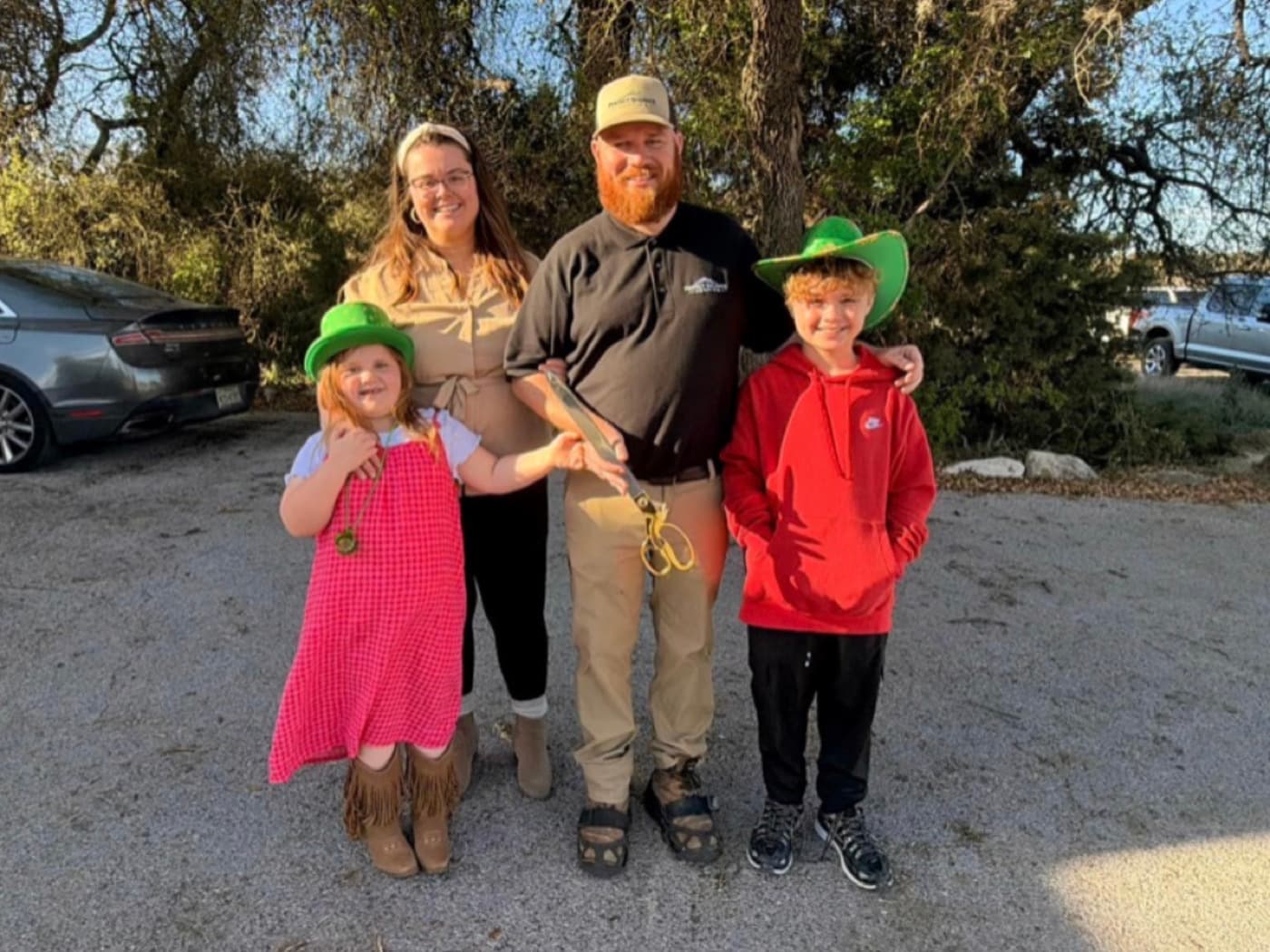 Christian Lazarow, founder of Perfect Balance Roofing, with his wife Kayla and their two children at the company's grand opening