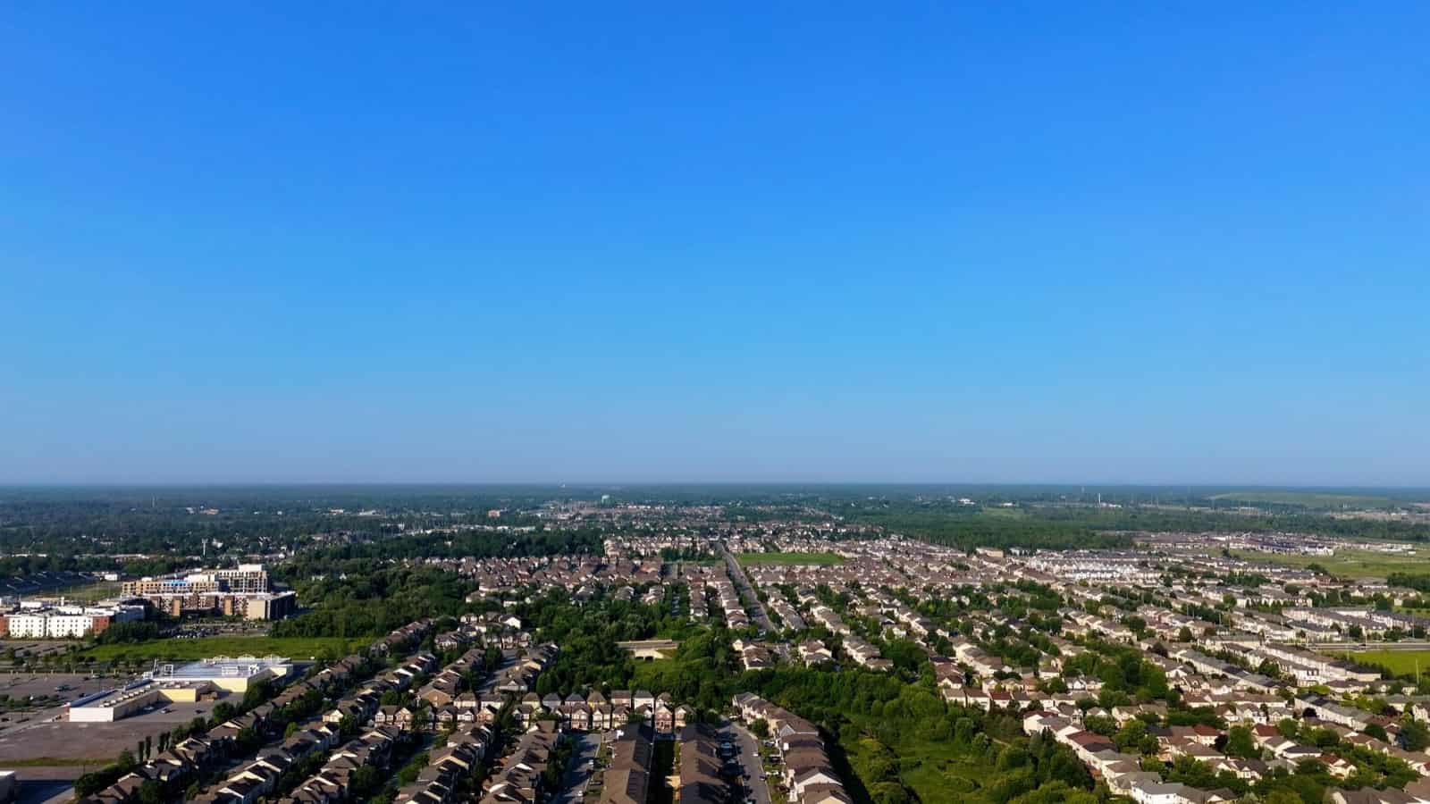 Aerial view of a residential suburb under a clear blue sky