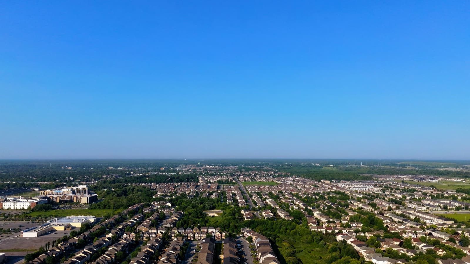 Aerial view of a residential suburb under a clear blue sky