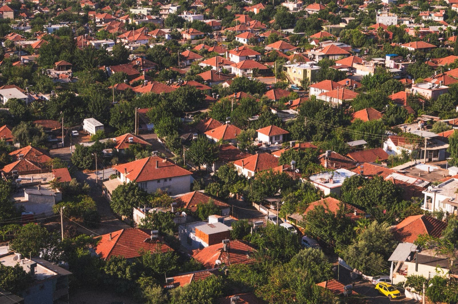Aerial view of a residential neighborhood with tile rooftops