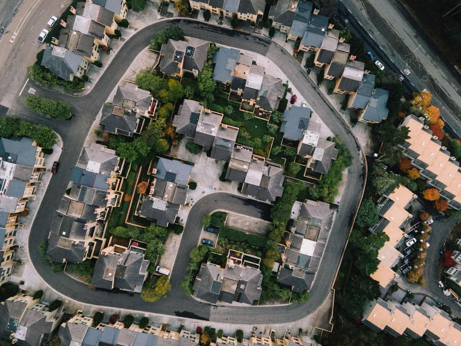 Aerial view of a residential neighborhood with curving, tree-lined streets