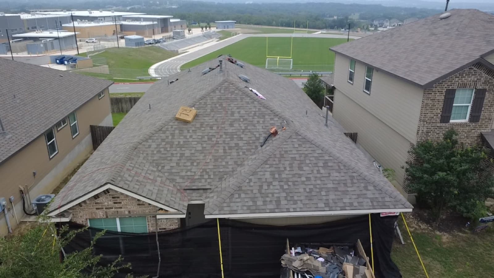 Completed shingle roof backing onto open green space