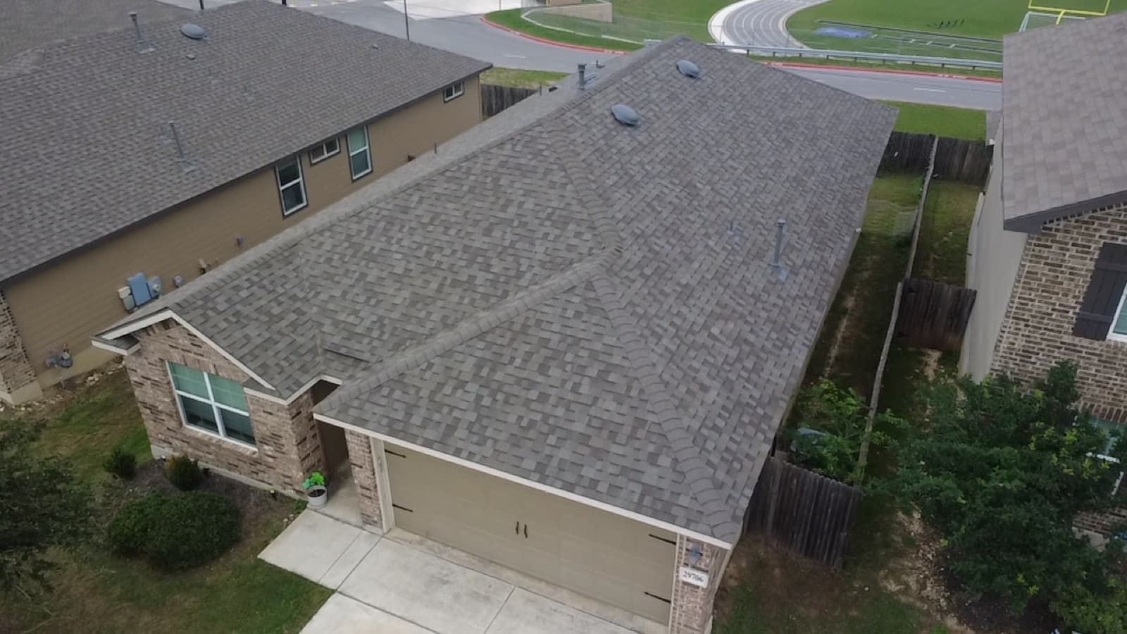 Completed gray hip roof on a San Antonio home, aerial view