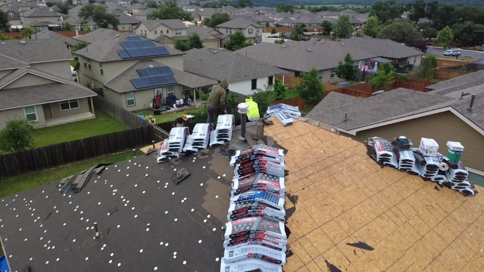 Crew and trucks on site for a residential roof replacement