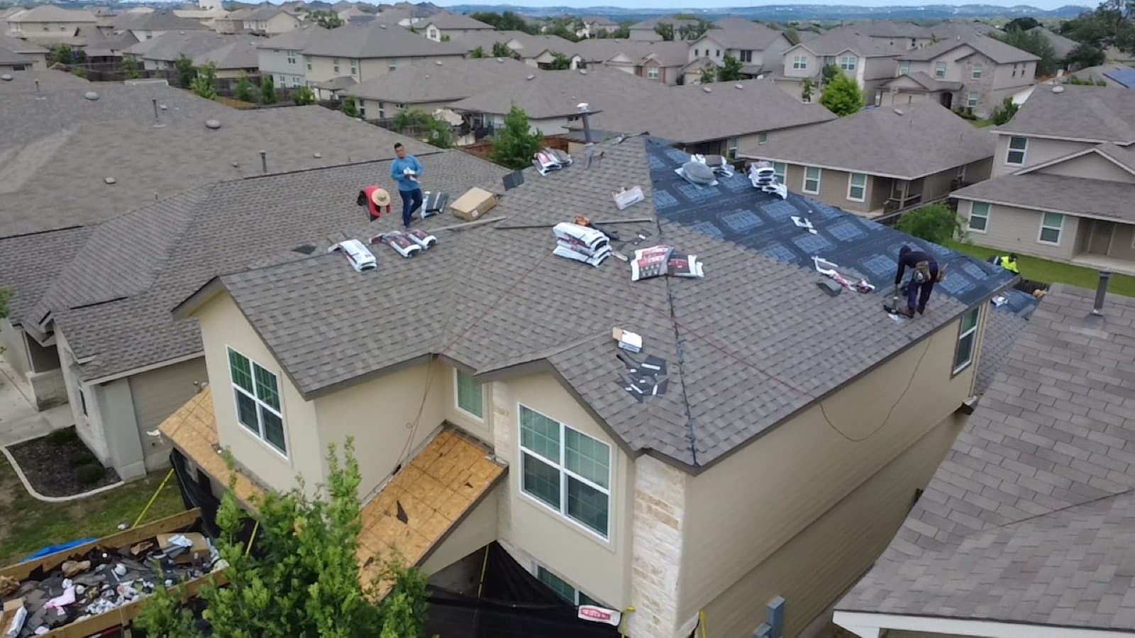 Perfect Balance Roofing crew installing a new roof on a two-story San Antonio home
