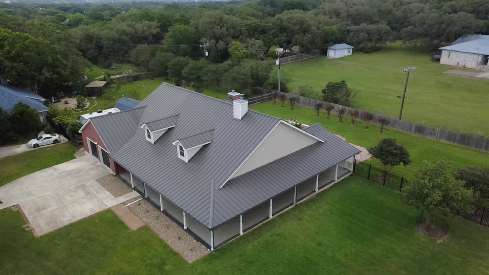 Full re-roof completed on a wide country ranch home with a wraparound porch