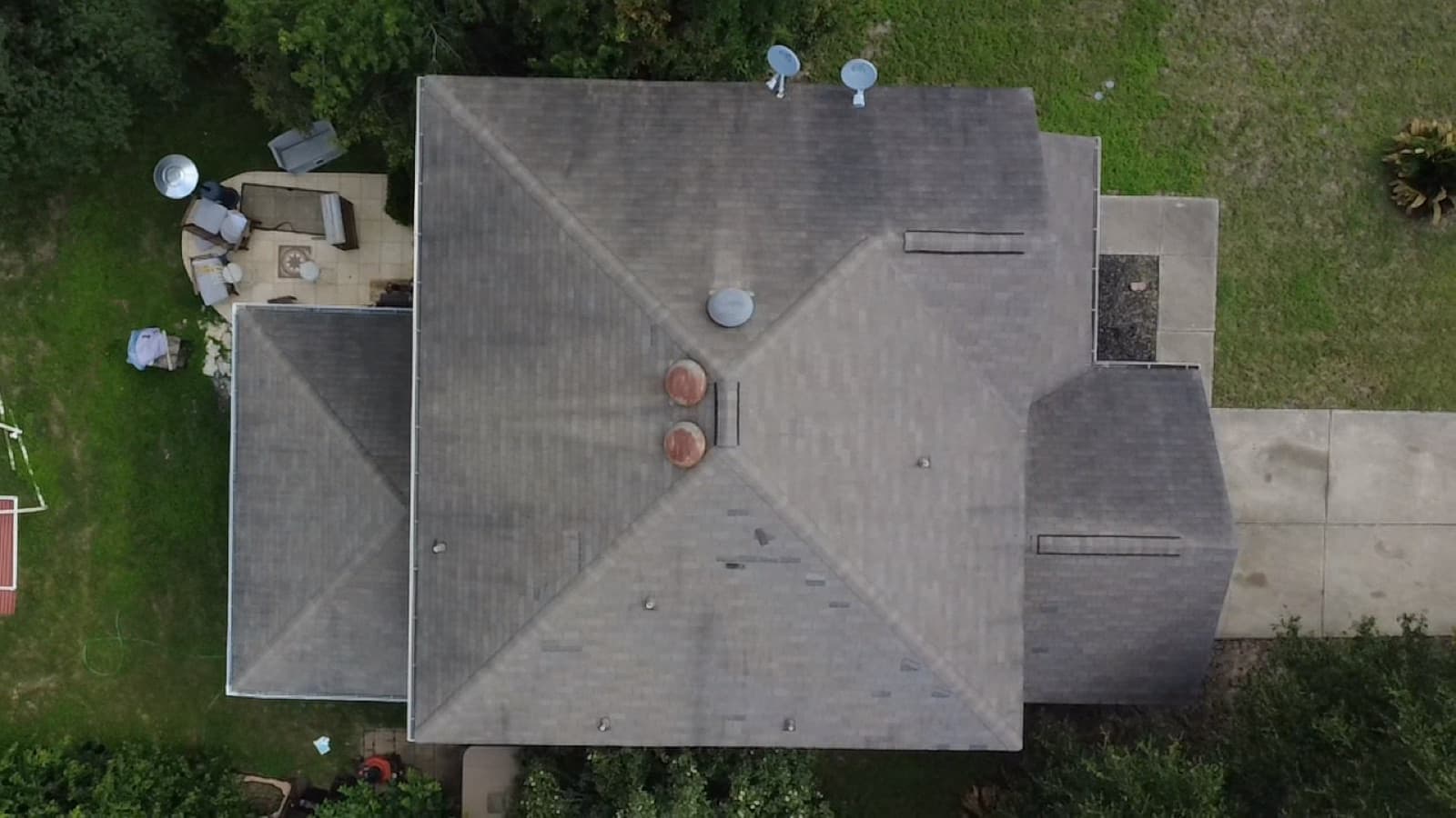Overhead view of a repaired roof with vents and flashing detailed