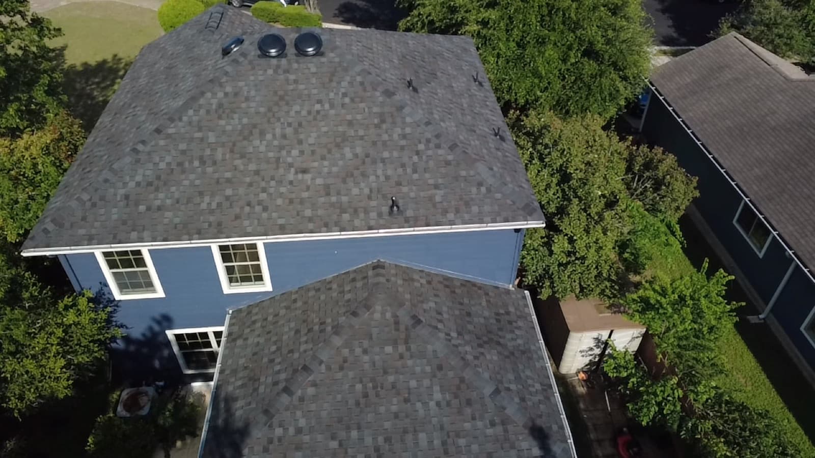 Completed gray architectural shingle roof on a Hill Country home