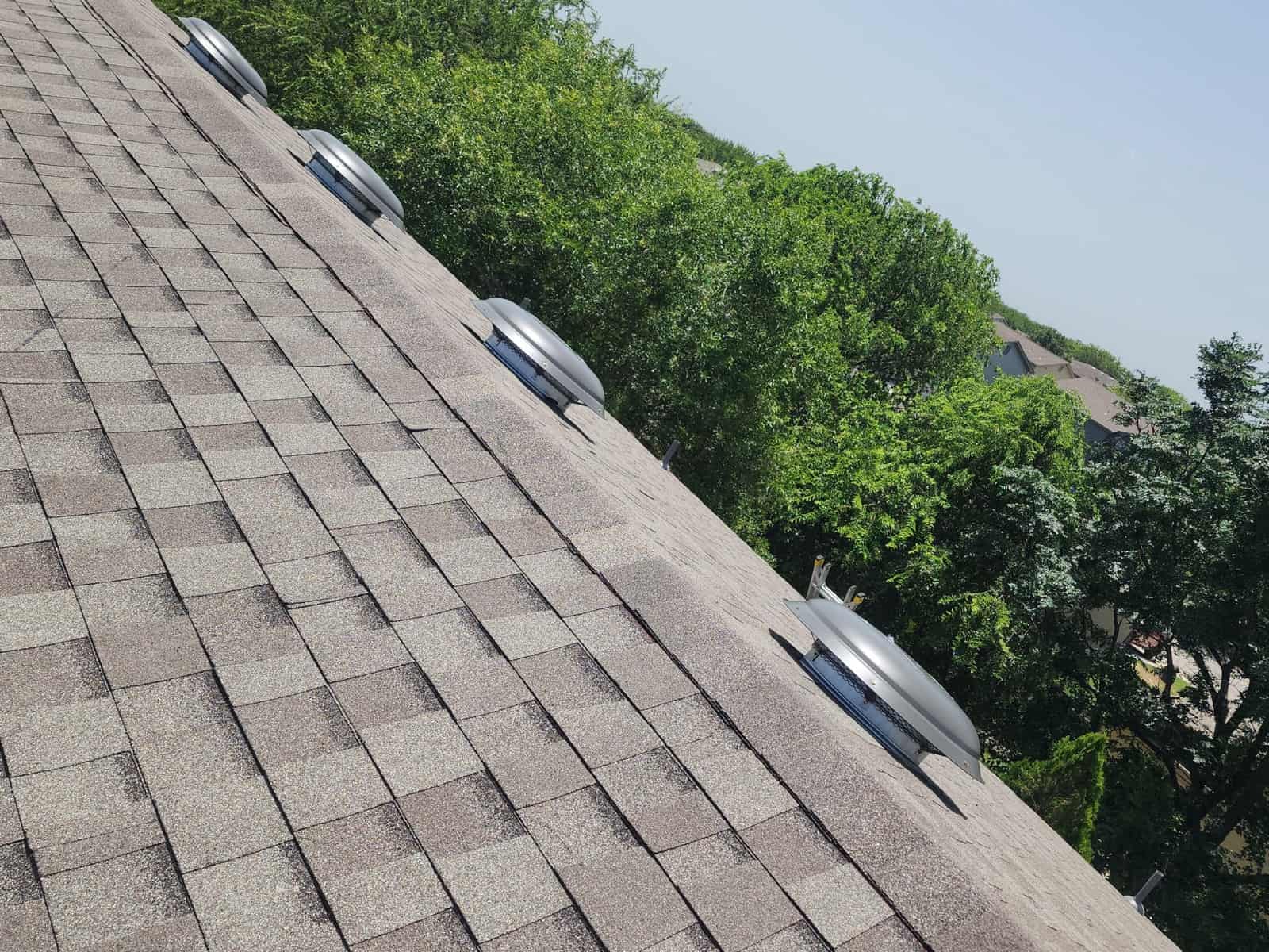 Close view of new architectural shingles running up to the ridge