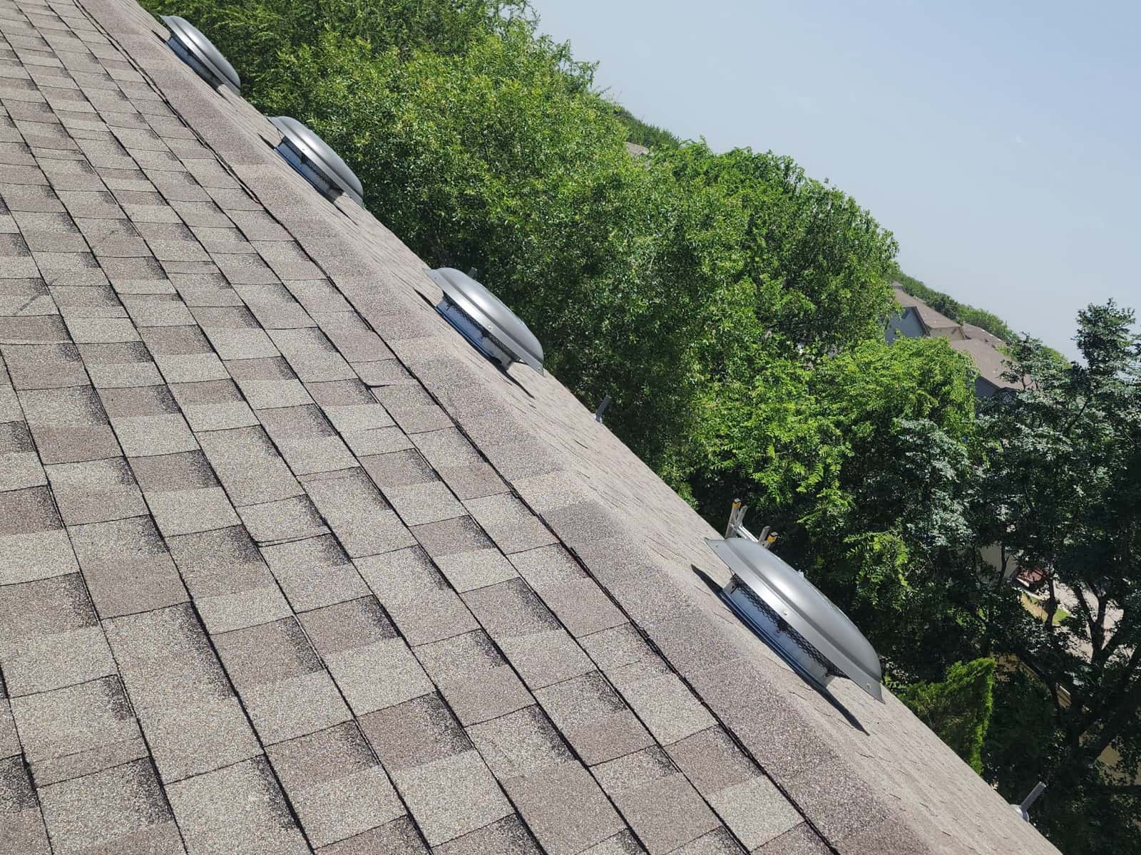 Close view of new architectural shingles running up to the ridge